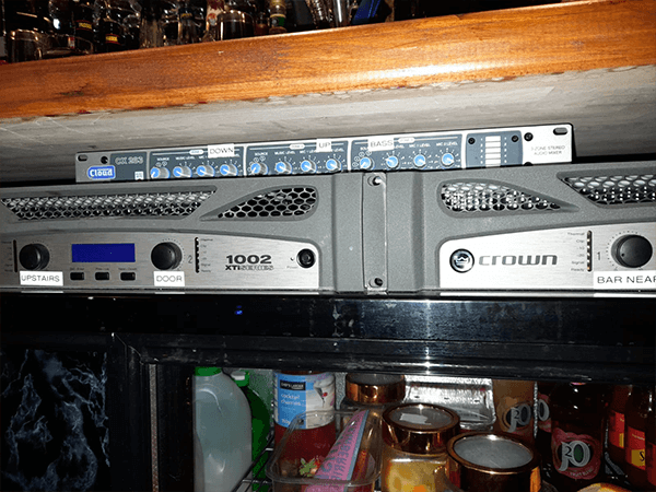 The power amplifier and zone mixers installed behind the bar as part of an audio visual sound system installation project in nottingham