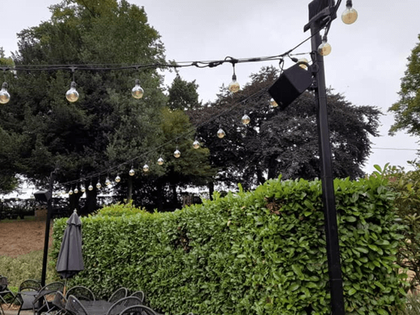 Black outdoor pa speaker on lighting pole for outdoor wedding venue