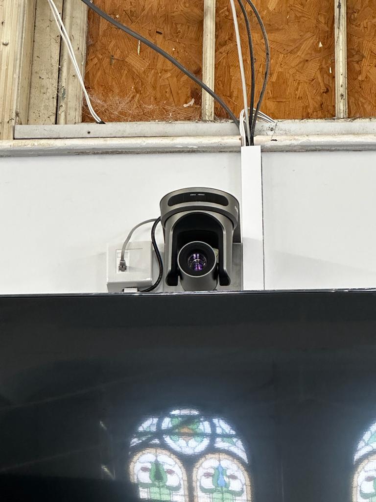video streaming camera on top of Tv as part of a church audio visual installation