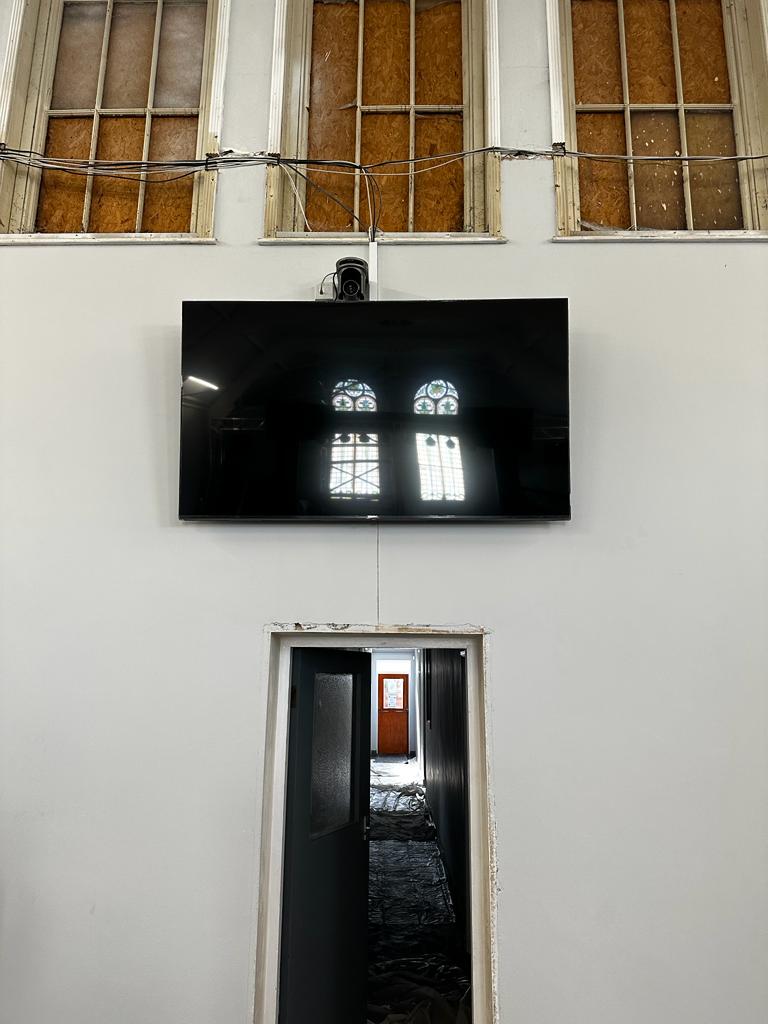 wall mounted tv and streaming camera as part of a church audio visual installation